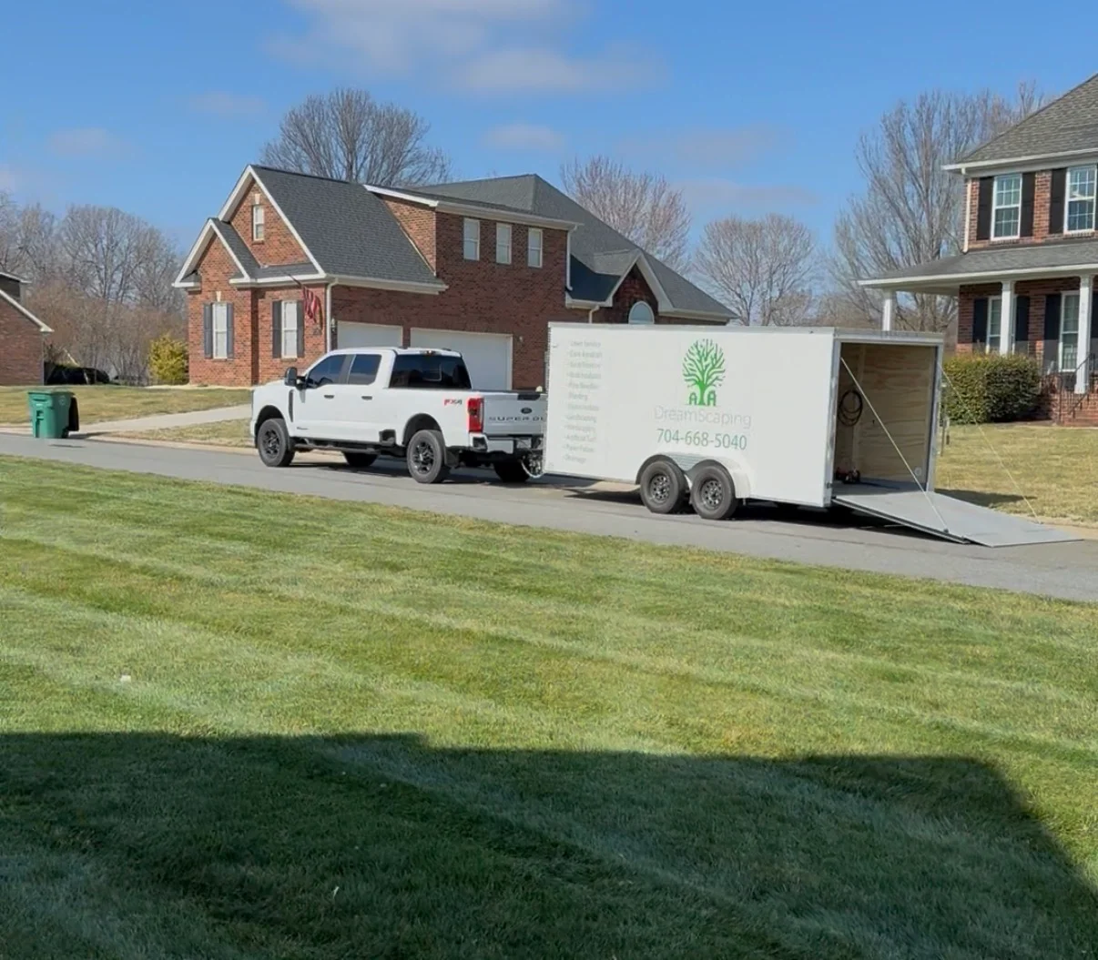 Custom landscape design with planted beds and graded terrain
