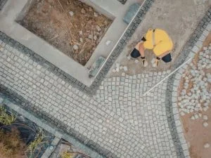 Aerial view of decorative stone paver patio with geometric patterns and mixed material borders